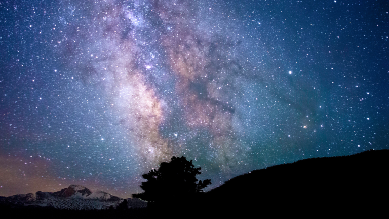 image of a blue and purple starry night sky to represent astrology